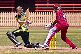 Australia's Meg Lanning sweeps during the West Indies tour of Australia in 2014. The wicket-keeper is Merissa Aguilleira.