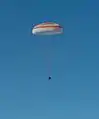 Soyuz TMA-07M descending with its main parachute deployed.