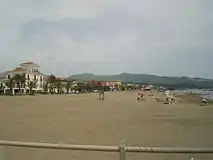 View of the beach of Marina di Casalvelino with the hills of Ascea in background