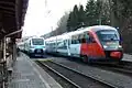 The InterCity Slovenija Pendolino and an S-Bahn S51 service next to each other in Spielfeld-Straß station, photographed from the north. The main platform can be seen on the far left. (2012)