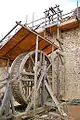 A treadwheel crane or 'squirrel cage' at Guédelon Castle.