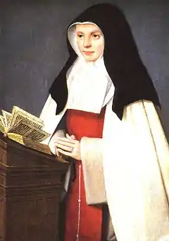 The religious habit of the Sisters of the Annunciation is white, with a red scapular and a black veil.