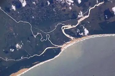 The old and new courses near the mouth, with the Msunduzi converging from the left (i.e. south), enclosing a wetland. Also mote the silt plume at sea.