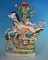 Staffordshire figure, c. 1860, depicting the punishment accorded to Mazeppa, after the popular poem by Lord Byron.  The artist has been unable to resist turning the horse into a zebra