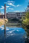 Stanley Woolen Mill, 1852, built by Moses Taft, with view of the Blackstone Canal, was the scene for two movies, The Great Gatsby, 1974, and Oliver's Story, 1978. In 1989, it had been the longest continuously operating family-owned mill in the US. This mill ran 24/7 making Civil War blue woolen cloth for military uniforms.