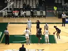 Image 7A player from Webber International  (black jersey) attempts a free throw against Stetson University (white jerseys). November 30, 2018.  (from Women's basketball)