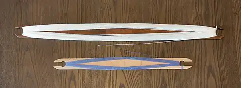 Stick shuttles wound in a figure-of-eight.