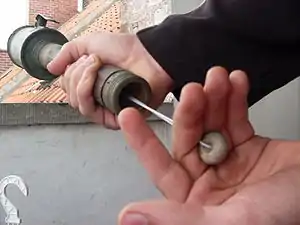 Exposed pull cord on M17 grenade.