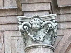 Capital with an angel who holds a festoon with his wings, in Stiftskirche Mariae Himmelfahrt in Schlägl (Austria)