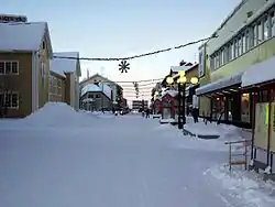 The main street (Storgatan) and December 2005 snow and Christmas lights in Gällivare at about noon.