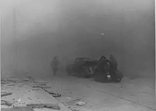 IPN copy #24(no caption)Zamenhofa Street between Wołyńska and Miła looking North, with burning Zamenhofa 29, 31 and 33 on the left.