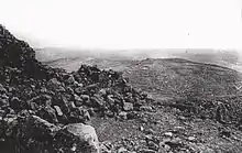 View of rocky ground and cultivated terraces in landscape extending to the horizon
