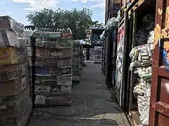 Stacks of sorted bottles and cans wait to be picked up for recycling.