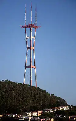An image of Sutro Tower, a red and white, three-legged truss TV and radio antenna tower