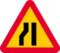 Road narrows on left sides