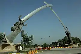 The Victory Arch (officially known as the Swords of Qādisīyah), dedicated in 1989, marks the entrances to the Grand Festivities Square in Baghdad, Iraq.