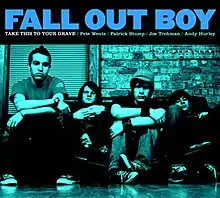 A blue image of all the band's members sitting against a garage door