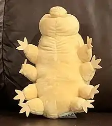 Stuffed toy representation of a tardigrade in a chair