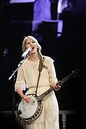 Taylor Swift on the Speak Now tour, dressed in white
