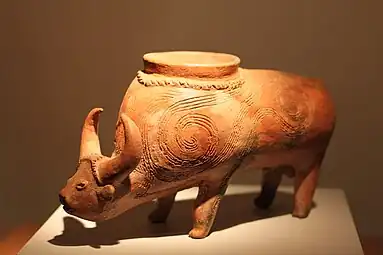Vessel in the form of a water buffalo from Lopburi; 2300 BC; ceramic; height: 18&nbsp;cm (7.mw-parser-output .frac{white-space:nowrap}.mw-parser-output .frac .num,.mw-parser-output .frac .den{font-size:80%;line-height:0;vertical-align:super}.mw-parser-output .frac .den{vertical-align:sub}.mw-parser-output .sr-only{border:0;clip:rect(0,0,0,0);clip-path:polygon(0px 0px,0px 0px,0px 0px);height:1px;margin:-1px;overflow:hidden;padding:0;position:absolute;width:1px}3⁄32 in.)