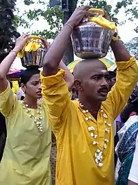 Devotees carry 'paal kudam' offerings at Thaipusam festival