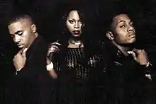 Promotional shot of The Firm in 1997, left to right: Nas, Foxy Brown, AZ