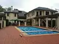 In 2011 before repairs to the roof. View from the back, showing the pool and BBQ area.