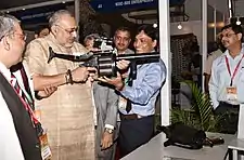 Minister holding a 40&nbsp;mm Multi Grenade Launcher (MGL) and on the table the 38&nbsp;mm Multi Shell Launcher both manufactured by OFT