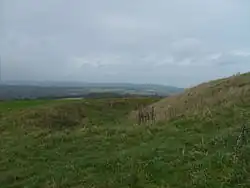 Rampart, ditch and bank of the Trundle Iron Age hillfort