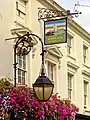 Scrolled iron lamp and sign brackets mentioned by Historic England