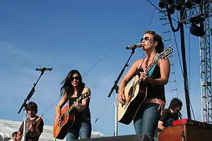 Jessica Harp (right) performing with Michelle Branch (center) as The Wreckers on June 2007.