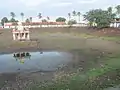 A view of the temple tank. see the image of the mandap in the puddle of water