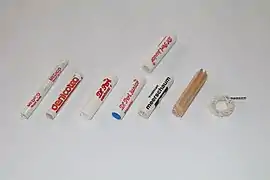 Smoking pipe filters. Left to right: 6&nbsp;mm paper. 6&nbsp;mm charcoal. 9&nbsp;mm paper. 9&nbsp;mm charcoal one-sided. 9&nbsp;mm meerschaum. 9&nbsp;mm balsa wood. Falcon dry ring.