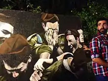 Artist Tomer Peretz and his piece 'Funeral' at an art exhibit 2012.