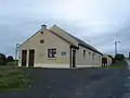 Tommy White Memorial Hall. Building started as a new church but was never finished. Later finished as a school and converted to a community centre after a new school was built.