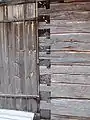 A locked or tooth-edge joint in the door corner of an old wooden storage building at the Lamminaho estate in Vaala, Finland.
