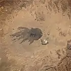 Satellite image of the Tousside volcano (large dark area in centre). Trou au Natron is visible below and to the right (smaller white area).