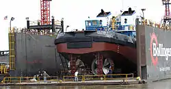 Towboat Dolphin I in Bollinger Shipyards floating Drydock #2 on the Mississippi River in Algiers, New Orleans, Louisiana