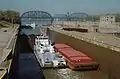 Towboat Steel Trader departing auxiliary lock at McAlpine Locks, 1987