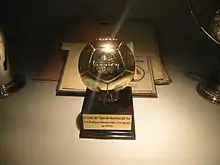 Football-shaped trophy, mounted on a base