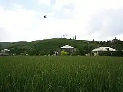A view of Tsovinar with a cemetery on the hill in the background, June 2009.