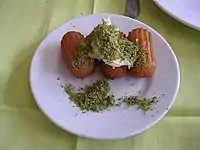 Tulumba with kaymak and pistachio