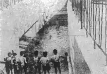 Onlookers observing damage