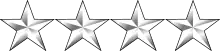 Four white metal stars in a horizontal row