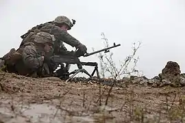 A U.S. Marine changing the barrel of the M240B