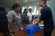 Aboard the Military Sealift Command (MSC) hospital ship, USNS&nbsp;Mercy, YN3 Dan S. Konzek demonstrates how to properly locate the brachial pulse to nurses from the Modilion General Hospital in Madang, Papua, New Guinea. USNS Mercy had just completed tsunami and earthquake relief operations in Indonesia (2005).