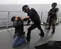 An Ecuadorian maritime interdiction-team, armed with MP5s, assigned to conduct a visit, board, search, and seizure exercise.