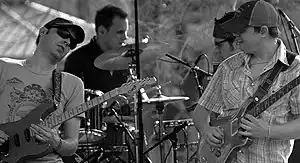 From left to right: Jake Cinninger, Kris Myers, Ryan Stasik and Brendan Bayliss performing at a Chili's parking lot in April 2007.