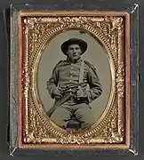 Private William Anthony Holland of Co. K, with Bowie knife and Colt Army Model 1860 revolver