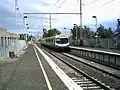 Southbound view from Platform 1, with an Upfield bound Comeng train arriving on Platform 2, in June 2004